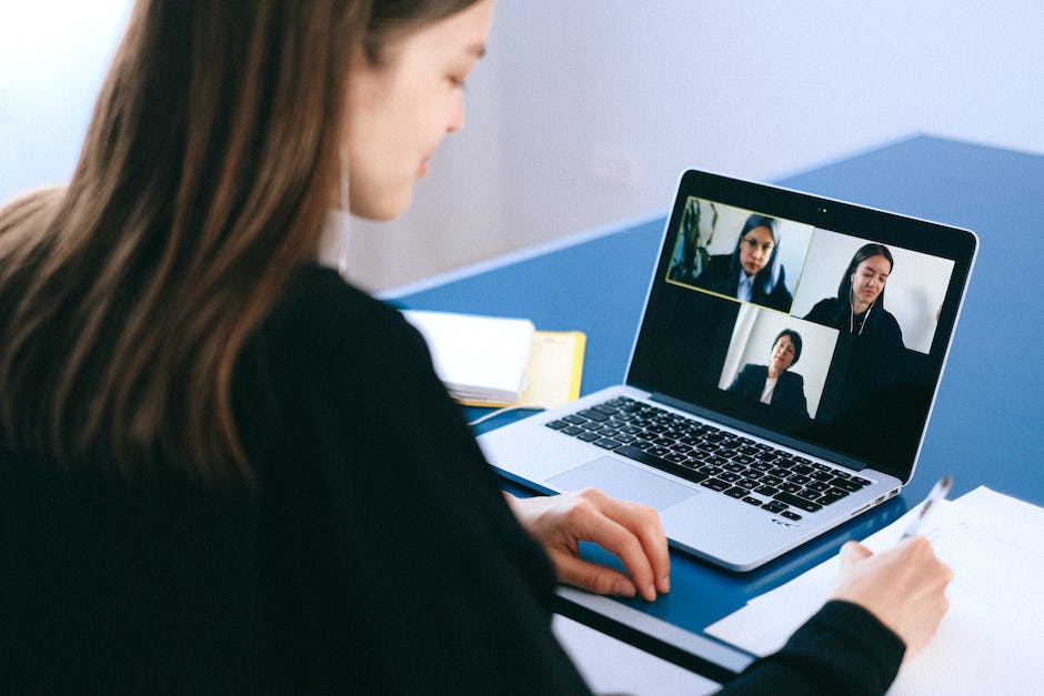 Image showing a person interviewing another person via a computer, to illustrate trends in virtual interviewing in 2023.